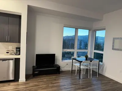 a kitchen and dining room with a table and chairs at Vine & Sunset Loft Free Parking and WIFI in Los Angeles