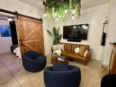a living room with a couch and two chairs and a tv at 4 Min Walk to Beach and Restaurants in Manhattan Beach