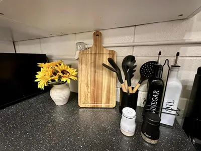 a counter with vases and a cutting board and flowers at 4 Min Walk to Beach and Restaurants in Manhattan Beach