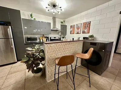 a kitchen with a counter and two stools in it at 4 Min Walk to Beach and Restaurants in Manhattan Beach