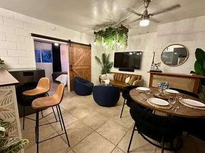 a large living room with a table and chairs at 4 Min Walk to Beach and Restaurants in Manhattan Beach
