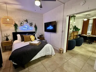 a bedroom with a large bed with a tv on the wall at 4 Min Walk to Beach and Restaurants in Manhattan Beach