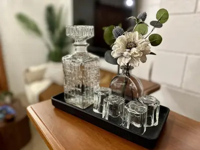a tray with glass bottles and glasses on a table at 4 Min Walk to Beach and Restaurants in Manhattan Beach
