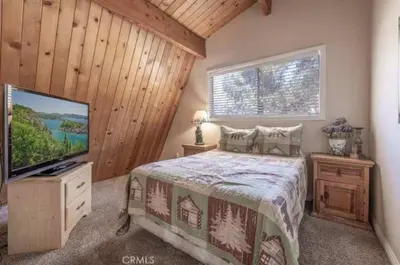 a bedroom with a bed and a flat screen tv at Navigate Stays Best Location Pet Friendly Games in Big Bear City