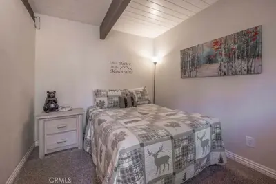 a bedroom with a bed and a picture on the wall at Navigate Stays Best Location Pet Friendly Games in Big Bear City