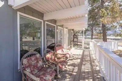 a porch with rocking chairs on a house at Navigate Stays Best Location Pet Friendly Games in Big Bear City