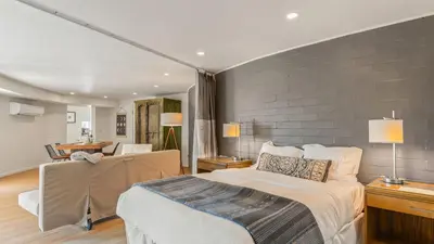a bedroom with a large bed and a living room at Malibu Hills Studio w Mountain Views Near beaches Cielo Nook by AvantStay in Malibu Beach