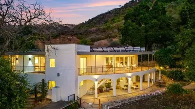 a large white house with a mountain in the background at Malibu Hills Studio w Mountain Views Near beaches Cielo Nook by AvantStay in Malibu Beach