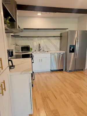 an empty kitchen with a stainless steel refrigerator at Echo Lake view condo - newly renovated - centrally located in Los Angeles
