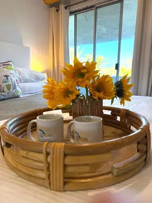 a tray with two cups and flowers on a bed at Echo Lake view condo - newly renovated - centrally located in Los Angeles