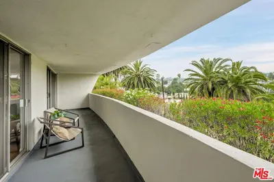 a balcony with a table and a view of a garden at Echo Lake view condo - newly renovated - centrally located in Los Angeles