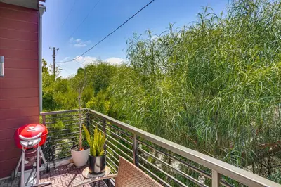a balcony with chairs and trees on a house at 2 Mi to Cabrillo Beach Luxe LA Gem with Balcony in San Pedro