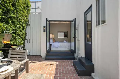 an open door to a bedroom with a bed at New Listing Midcity West Villa by Colby & Conrad in Los Angeles