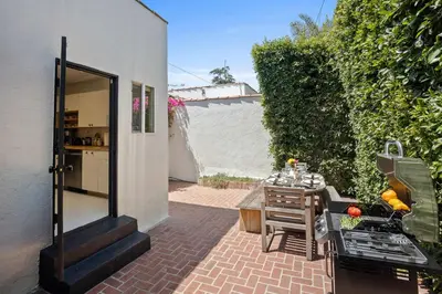a small patio with a table and a grill at New Listing Midcity West Villa by Colby & Conrad in Los Angeles