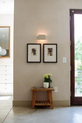 a table in a room with two pictures on the wall at Stylish Penthouse in West Hollywood in Los Angeles