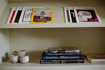 a shelf with books and cups on top at Stylish Penthouse in West Hollywood in Los Angeles