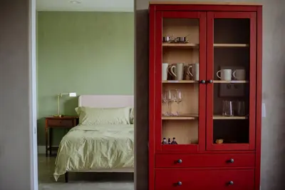 a red cabinet in a bedroom with a bed at Cozy Charm in West Hollywood in Los Angeles