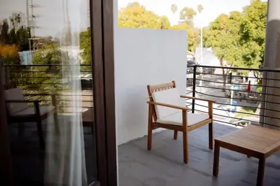 a chair on a balcony with a view at Cozy Charm in West Hollywood in Los Angeles