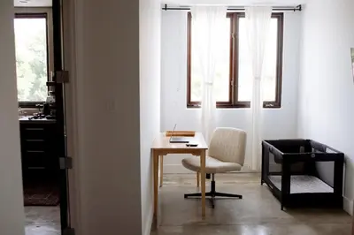 a room with a desk and a chair and a window at Cozy Charm in West Hollywood in Los Angeles