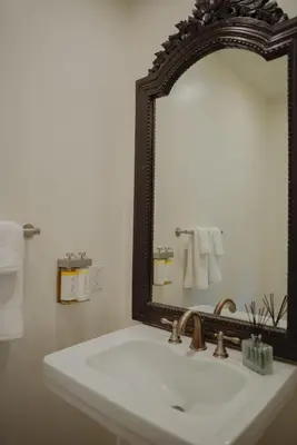 a bathroom with a white sink and a mirror at Dreamy Mid-Century Modern Pad in Los Angeles