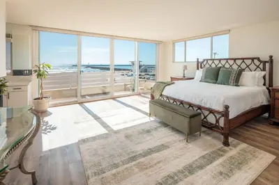 a bedroom with a bed and a large window at Time2Relax in Oxnard