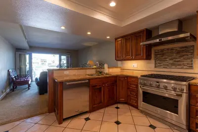 a kitchen with wooden cabinets and a stove top oven at Harbor View in Oxnard