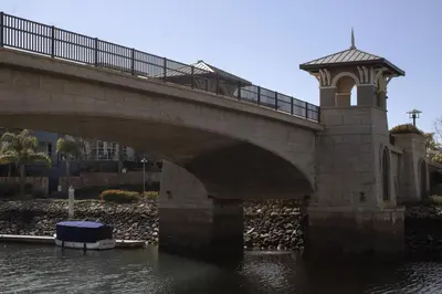 a bridge over a body of water with a building at Harbor View in Oxnard