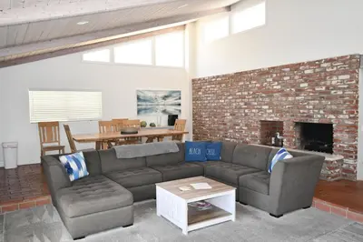 a living room with a couch and a brick fireplace at Ocean Blue in Oxnard