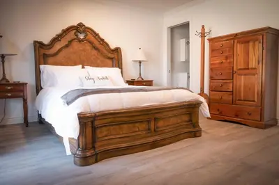 a bedroom with a large bed with a wooden headboard at Surfside Four in Port Hueneme