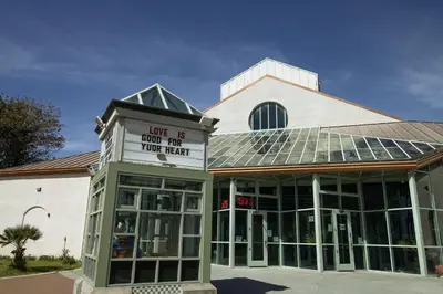 a building with a sign that reads love is book for your heart at Surfside Four in Port Hueneme