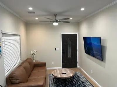 a living room with a couch and a ceiling fan at House in Torrance