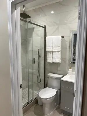 a bathroom with a shower and a toilet and a sink at House in Torrance