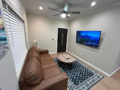 a living room with a brown couch and a table at House in Torrance