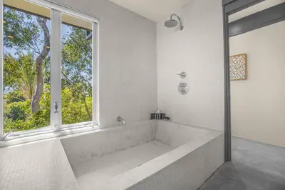 a white bathroom with a tub and a window at Solara Point in Los Angeles