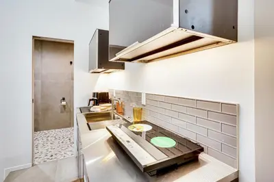 a kitchen with a counter in a room at Shop, Dine and Walk to Ocean Redondo Beach Apt! in Redondo Beach