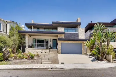 a house with a garage in front of it at Shop, Dine and Walk to Ocean Redondo Beach Apt! in Redondo Beach