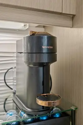 a coffee maker sitting on top of a glass shelf at The Amber Serene Peaceful Retreat Pool Gym And Jacuzzi in Los Angeles