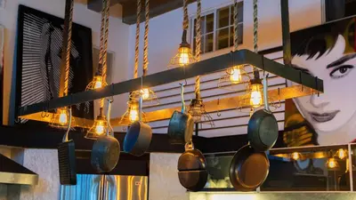 a bunch of pots and pans hanging from a wall at Skyline Lofts by AvantStay: a multi-level industrial-chic retreat in DTLA with rooftop views soaring ceilings steps to dining music culture in Los Angeles