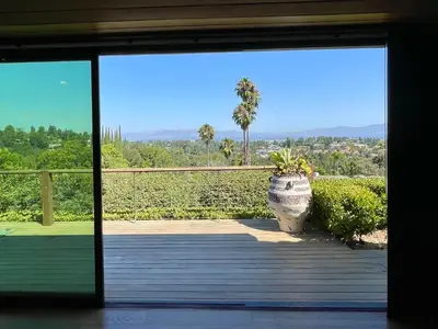 a door open to a porch with a plant at Spectacular City Mountain Views Remodeled Open Plan 3 bdr Home Pool Jacuzzi Oasis in Engine Company Number 109 Heliport
