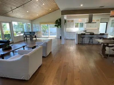 a living room with white furniture and a kitchen at Spectacular City Mountain Views Remodeled Open Plan 3 bdr Home Pool Jacuzzi Oasis in Engine Company Number 109 Heliport