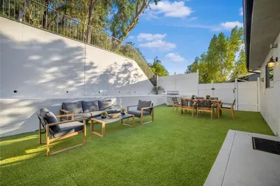 a patio with chairs and a table on grass at Rancho Haven in Los Angeles
