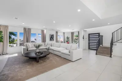 a living room with a white couch and a table at Rancho Haven in Los Angeles