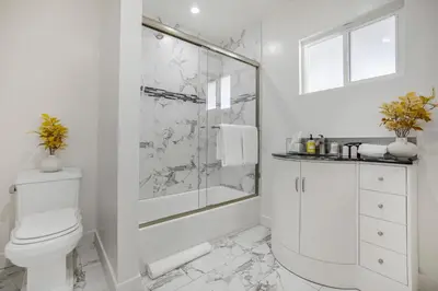 a white bathroom with a shower and a toilet at Rancho Haven in Los Angeles