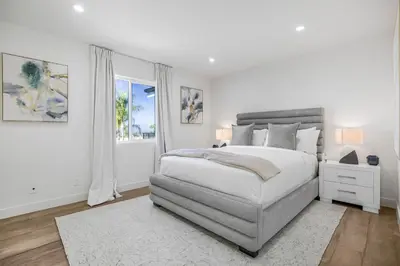 a white bedroom with a bed and a window at Rancho Haven in Los Angeles