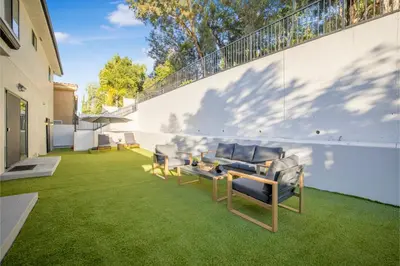 a patio with chairs and a table on the grass at Rancho Haven in Los Angeles
