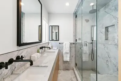 a bathroom with two sinks and a shower at Playa Del Sol by Stay Awhile Villas in Malibu Beach