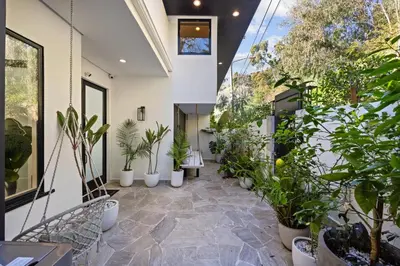 an indoor garden with potted plants in a building at Six Senses by Stay Awhile Villas in Los Angeles