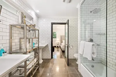 a bathroom with a tub and a toilet and a sink at Six Senses by Stay Awhile Villas in Los Angeles