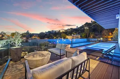 a balcony with a view of a swimming pool at Six Senses by Stay Awhile Villas in Los Angeles