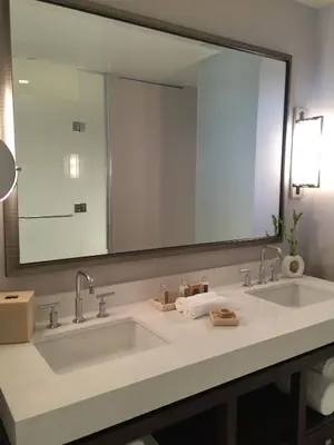 a bathroom with two sinks and a large mirror at Parkwest Bicycle Casino in Bell Gardens